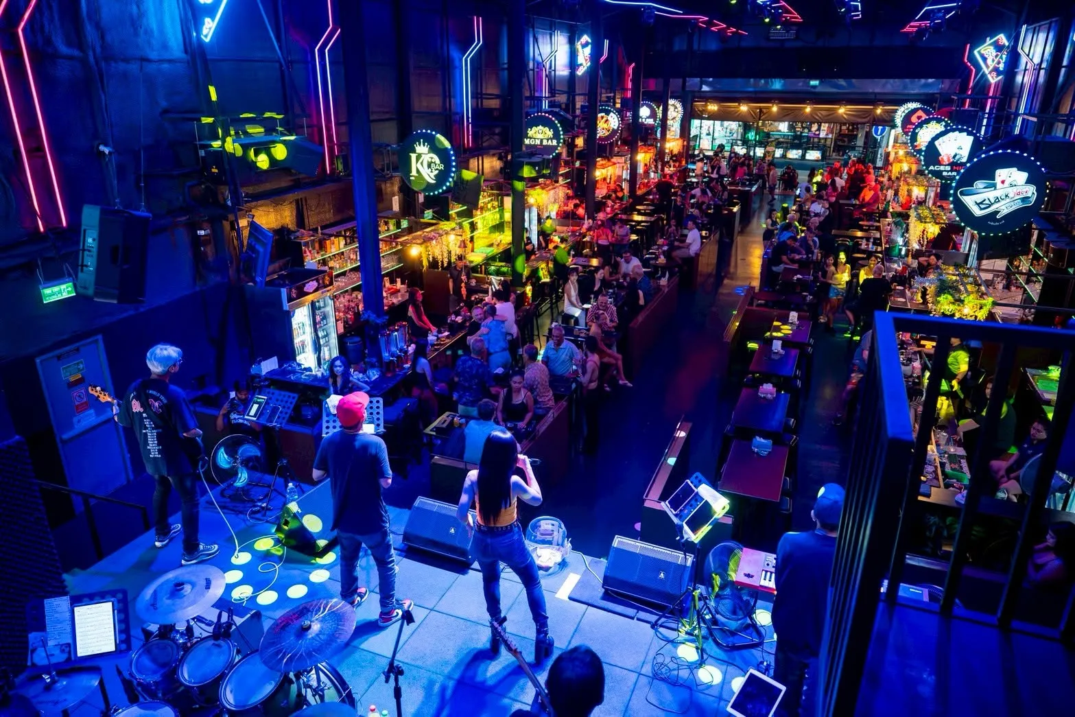The whole of Las Vegas Beer Garden seen from the stage, with the KQ Bar sign at the left of the picture and the entrance far away at the end of the walkway