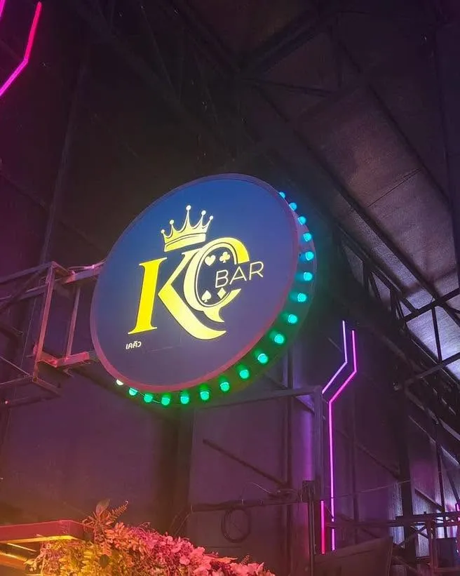 The KQ Bar sign: a black disc ringed with bulbs, a gold crown over the letters K and Q